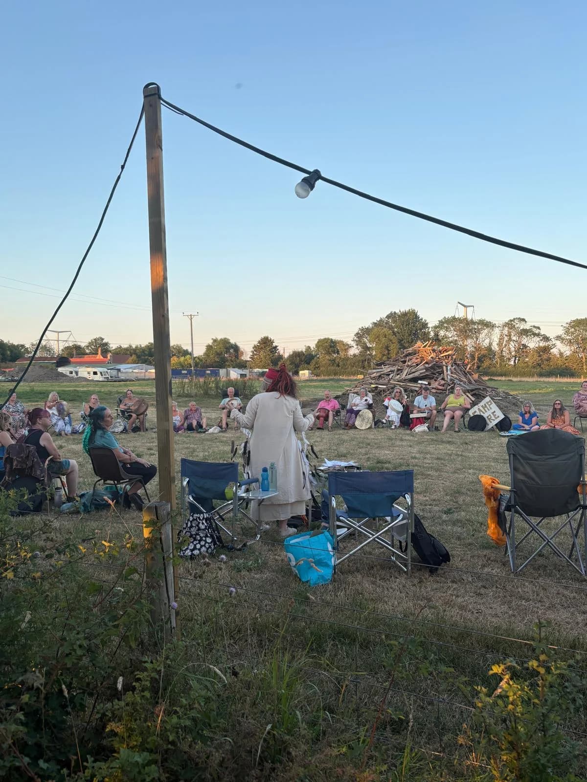 A circle of campers gathered in the field at Merry Farm